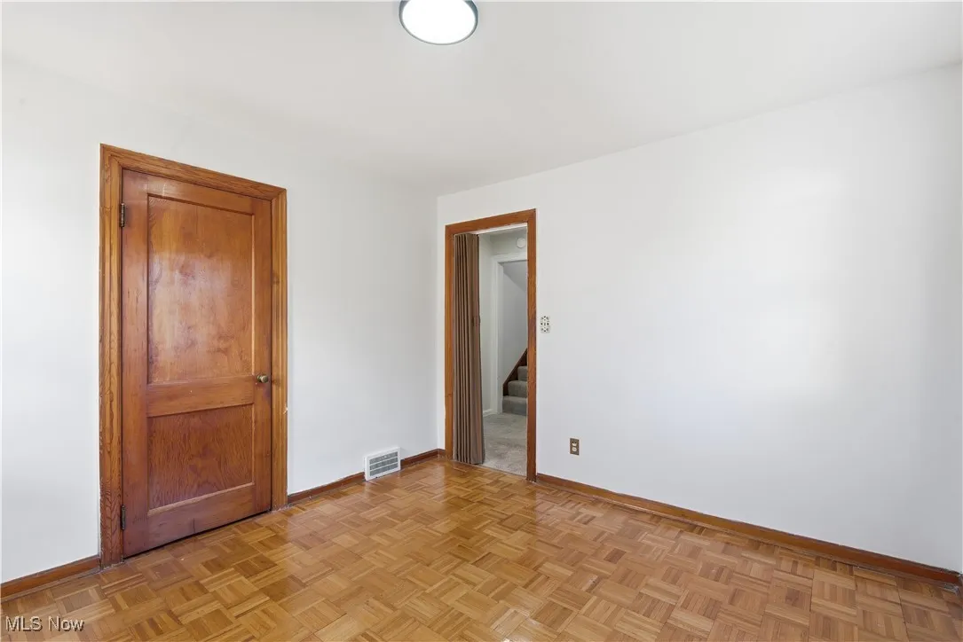 Unfurnished room featuring baseboards and stairs