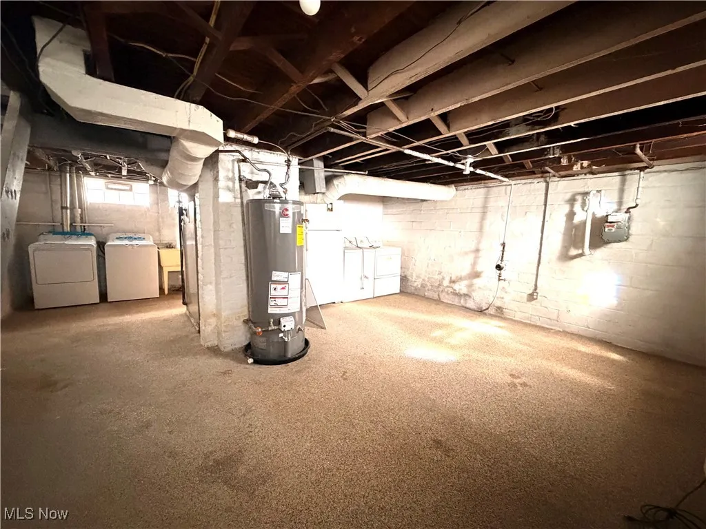 Basement featuring gas water heater and independent washer and dryer
