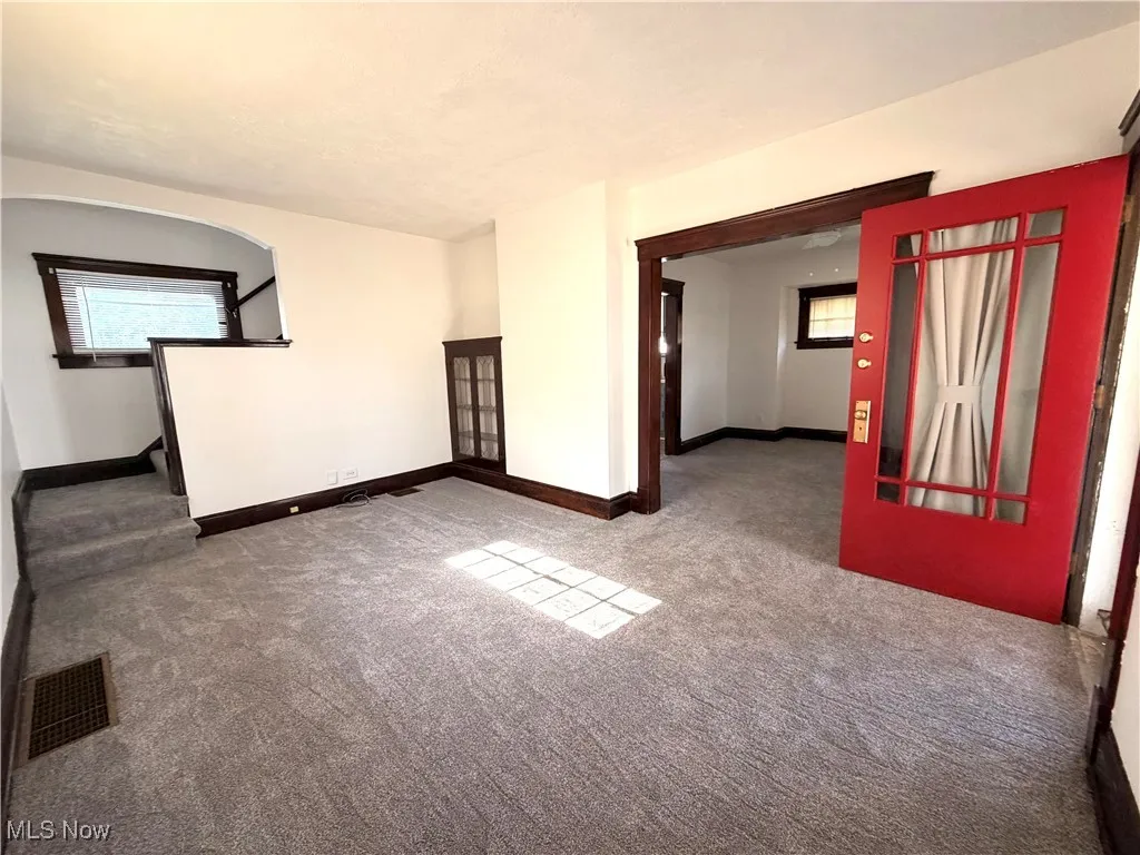 Spare room featuring carpet flooring and plenty of natural light