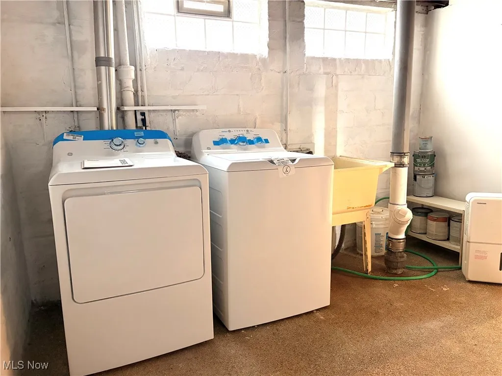 Washroom featuring independent washer and dryer