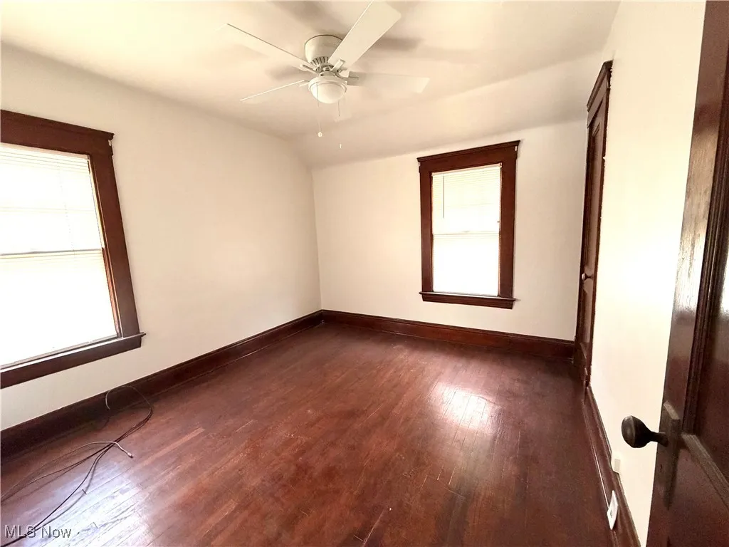 Unfurnished room with hardwood / wood-style flooring and a ceiling fan