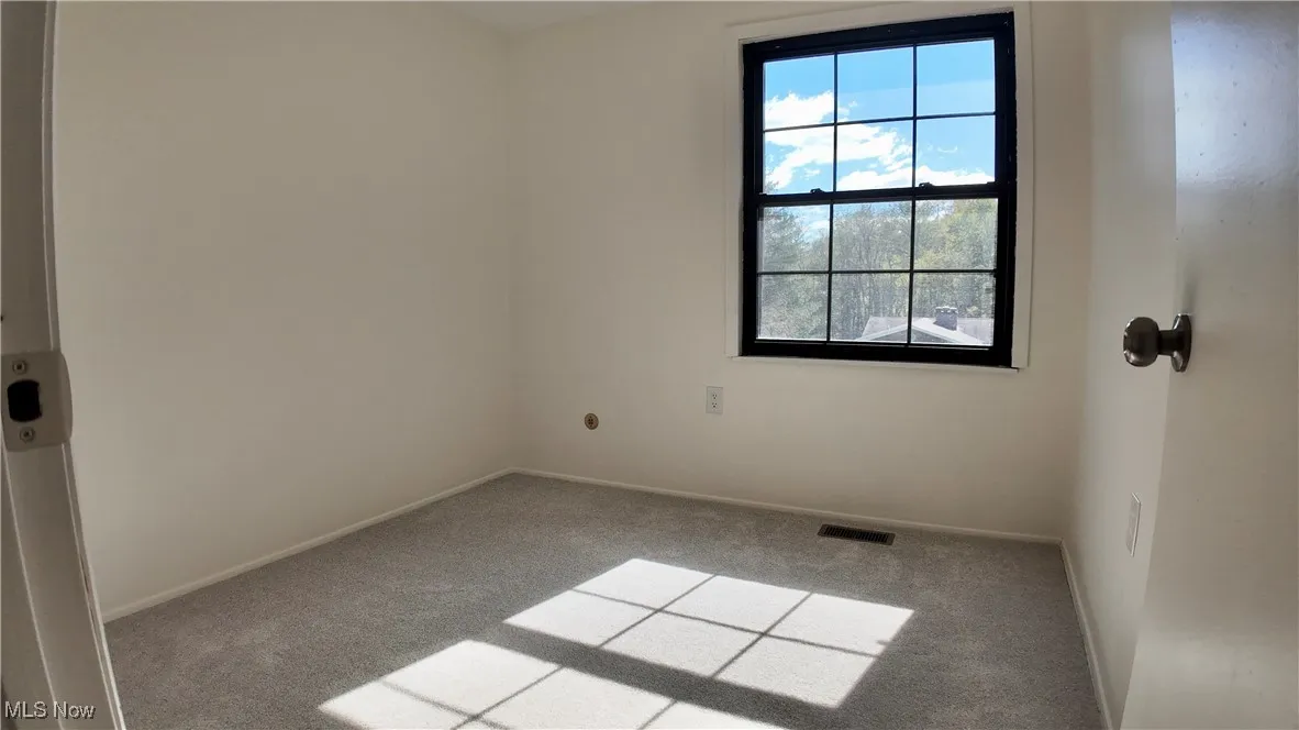Empty room with carpet floors