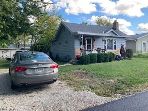 View of front of house featuring a front yard and a chimney