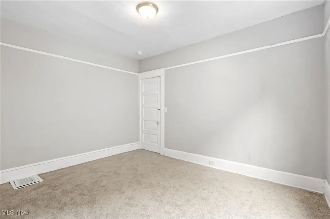 Unfurnished room with baseboards and carpet