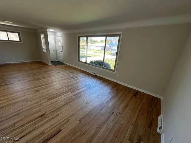 Unfurnished living room featuring wood finished floors