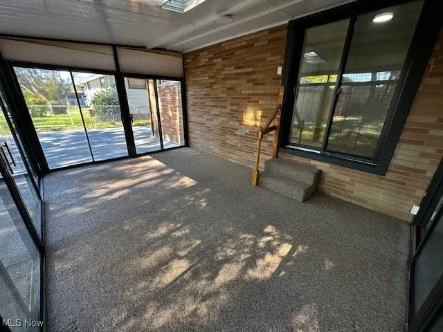 Unfurnished sunroom featuring plenty of natural light