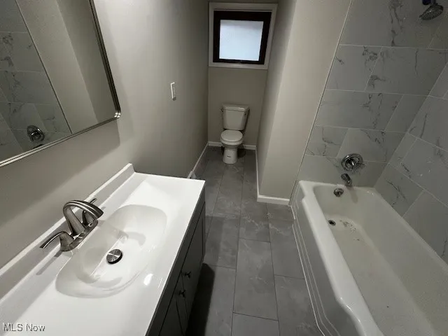 Full bath with vanity and shower / tub combination