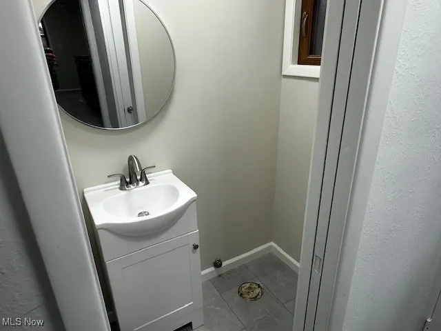 Bathroom with tile patterned flooring and vanity