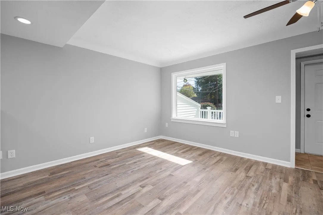 Unfurnished room featuring a ceiling fan and light wood-style flooring