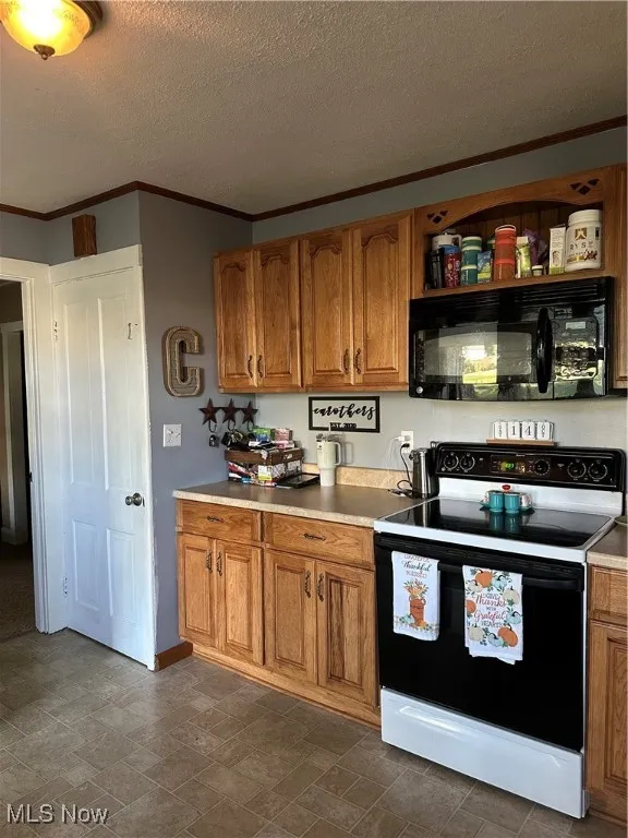 Kitchen featuring white range, brown cabinets, black microwave, crown molding, and a textured ceiling