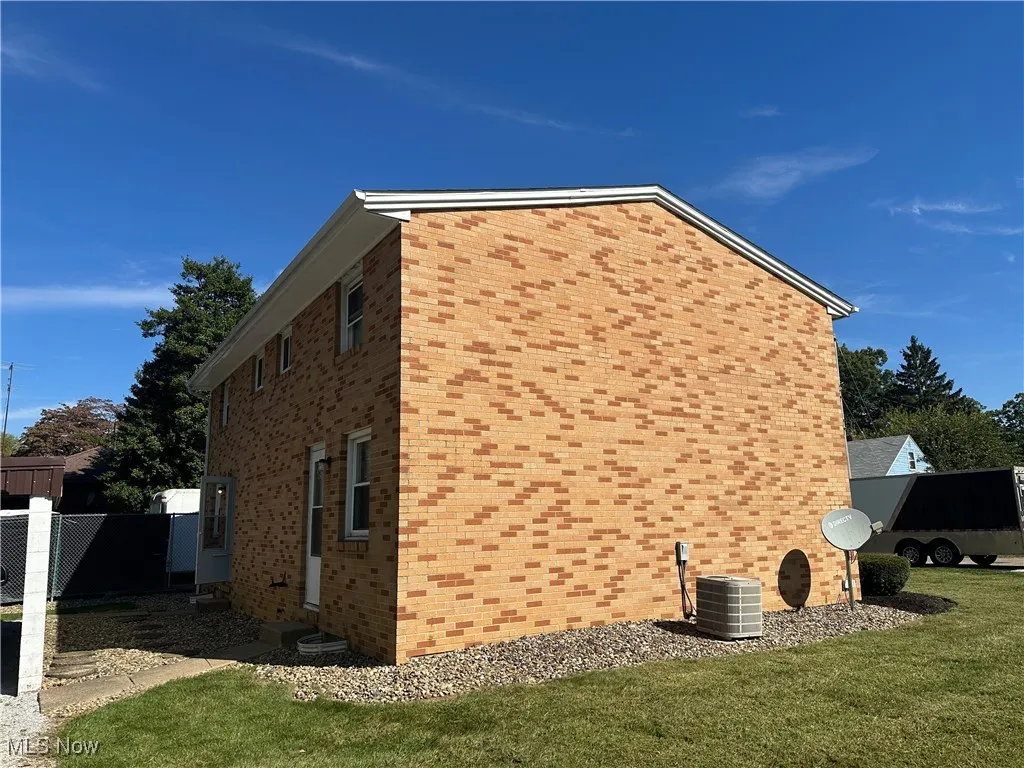 View of side of property featuring brick siding