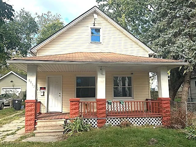 View of front of home with a porch and a shingled roof