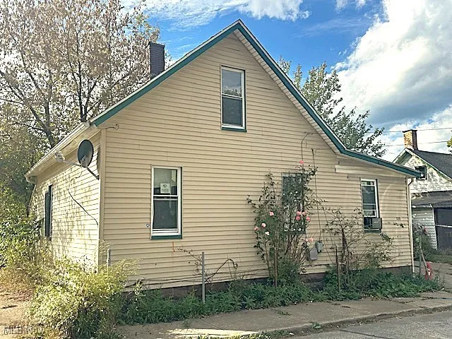 View of property exterior featuring a chimney