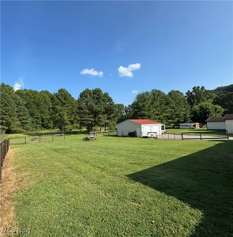 View of yard with an outbuilding, a pole building, and a view of rural / pastoral area