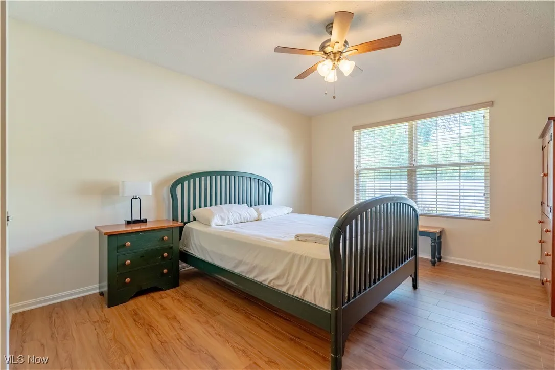 Bedroom with light wood finished floors and ceiling fan