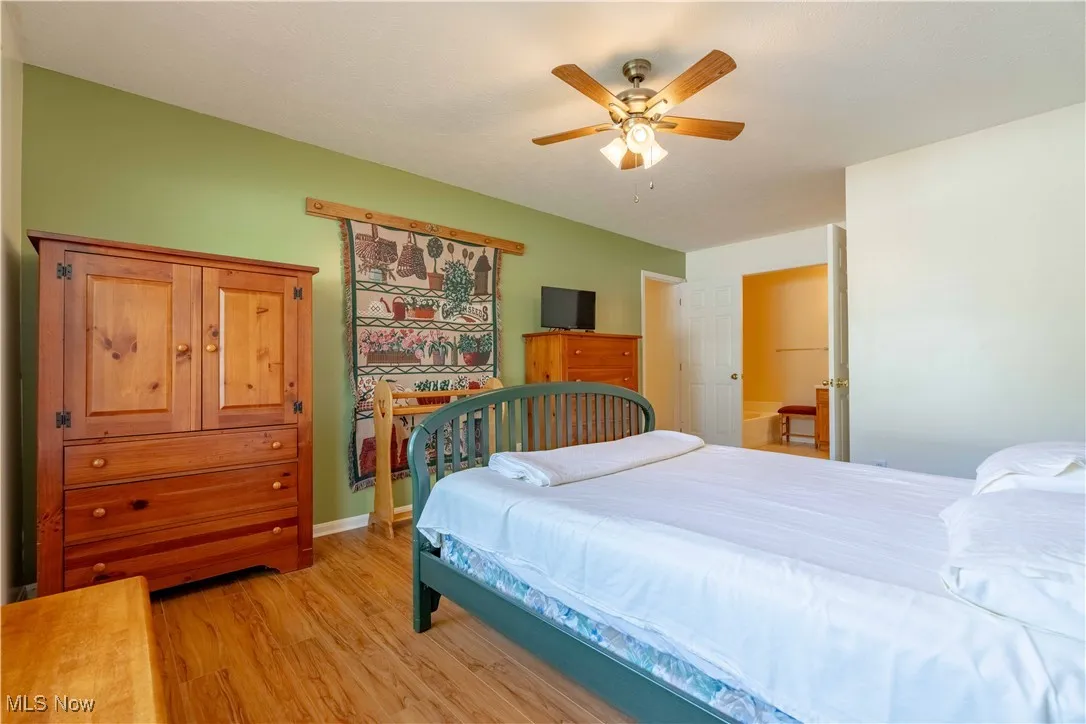 Bedroom with light wood-style flooring and a ceiling fan