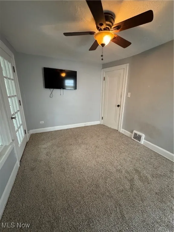 Carpeted empty room featuring baseboards and ceiling​​‌​​​​‌​​‌‌​‌‌​​​‌‌​‌​‌​‌​​​‌​​ fan
