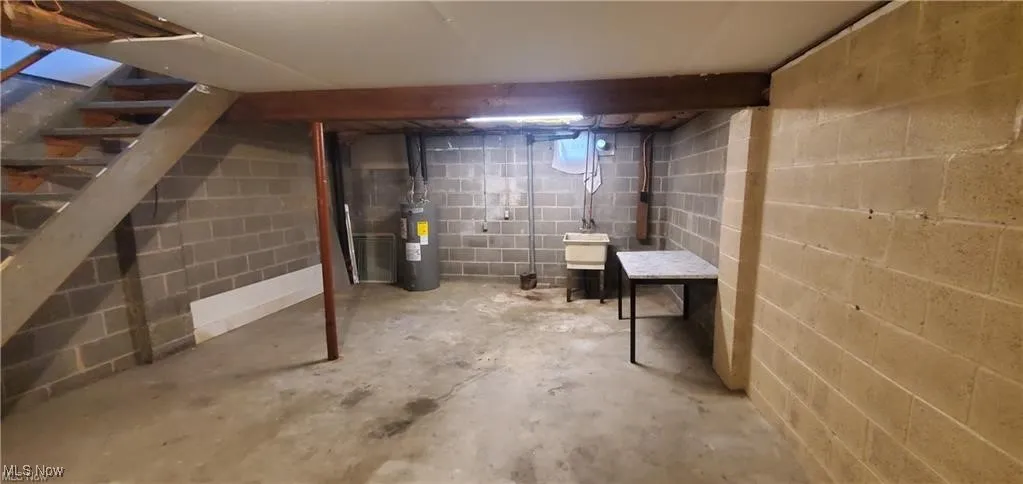 Unfinished below grade area with electric water heater