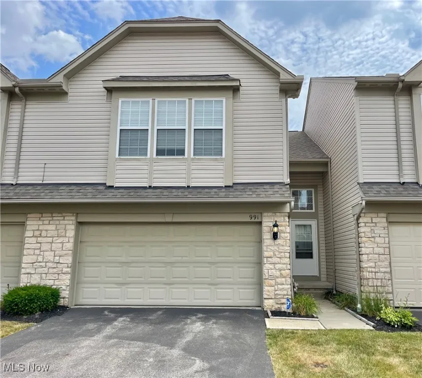 View of front of home with stone and vinyl siding.