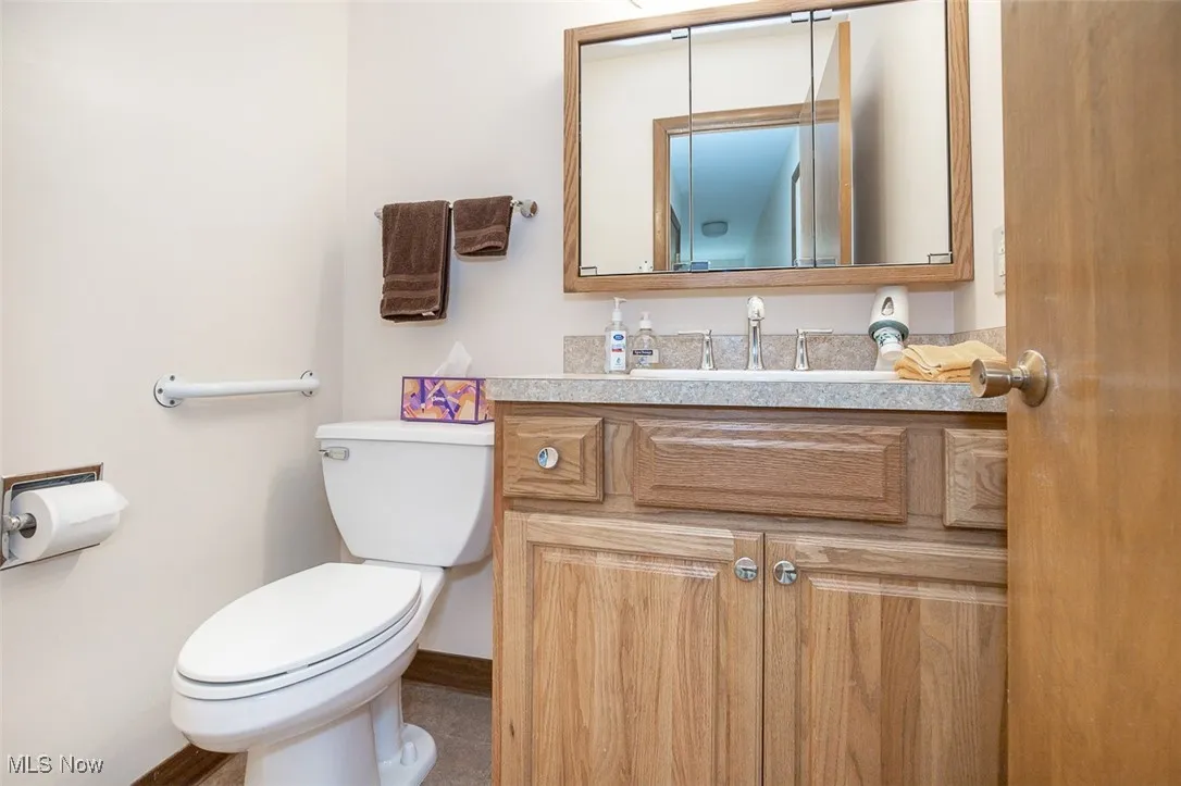 Half bathroom with vanity and toilet
