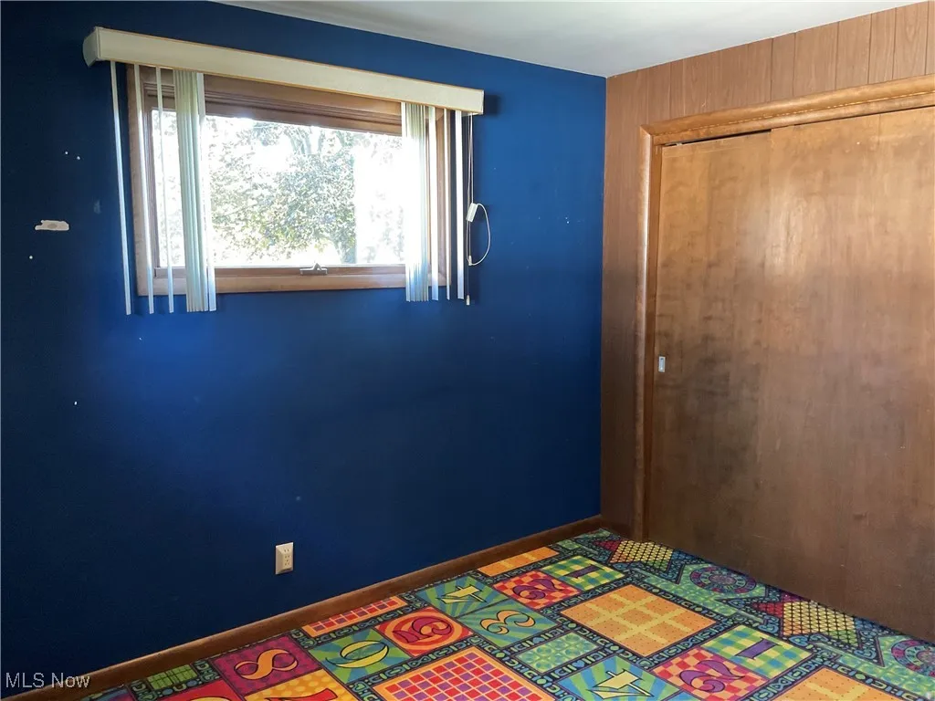 Unfurnished bedroom with baseboards and a closet
