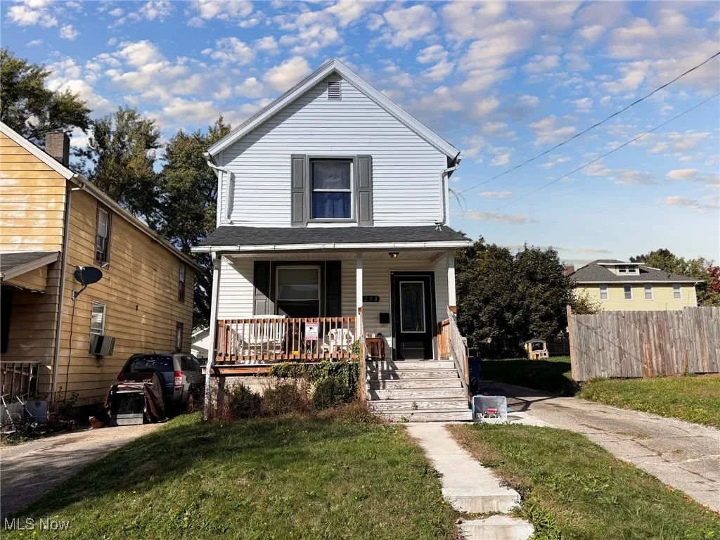 View of front of house featuring covered porch and a front lawn