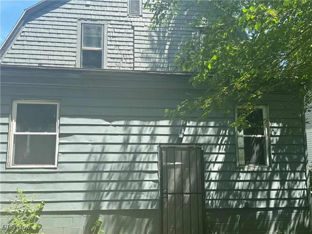 View of property exterior featuring a gambrel roof