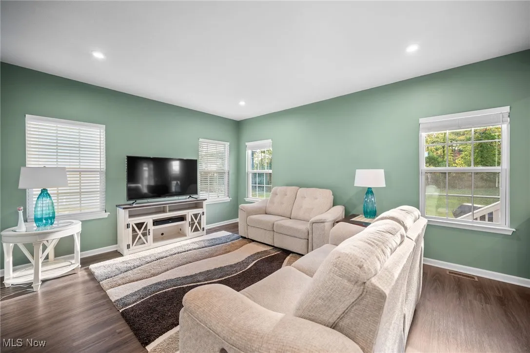 Living area featuring wood finished floors and recessed lighting