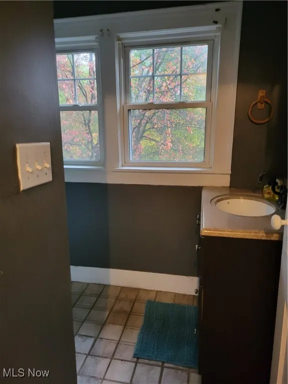 Bathroom with vanity and light tile patterned floors