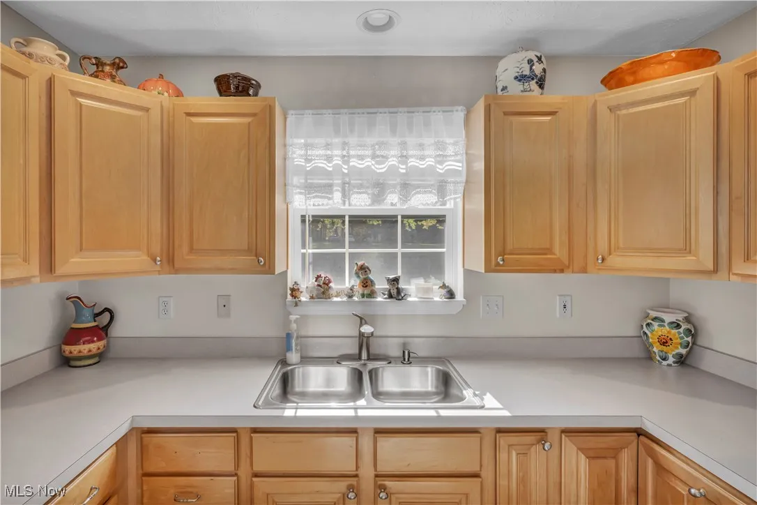 Kitchen with light countertops and light brown cabinets