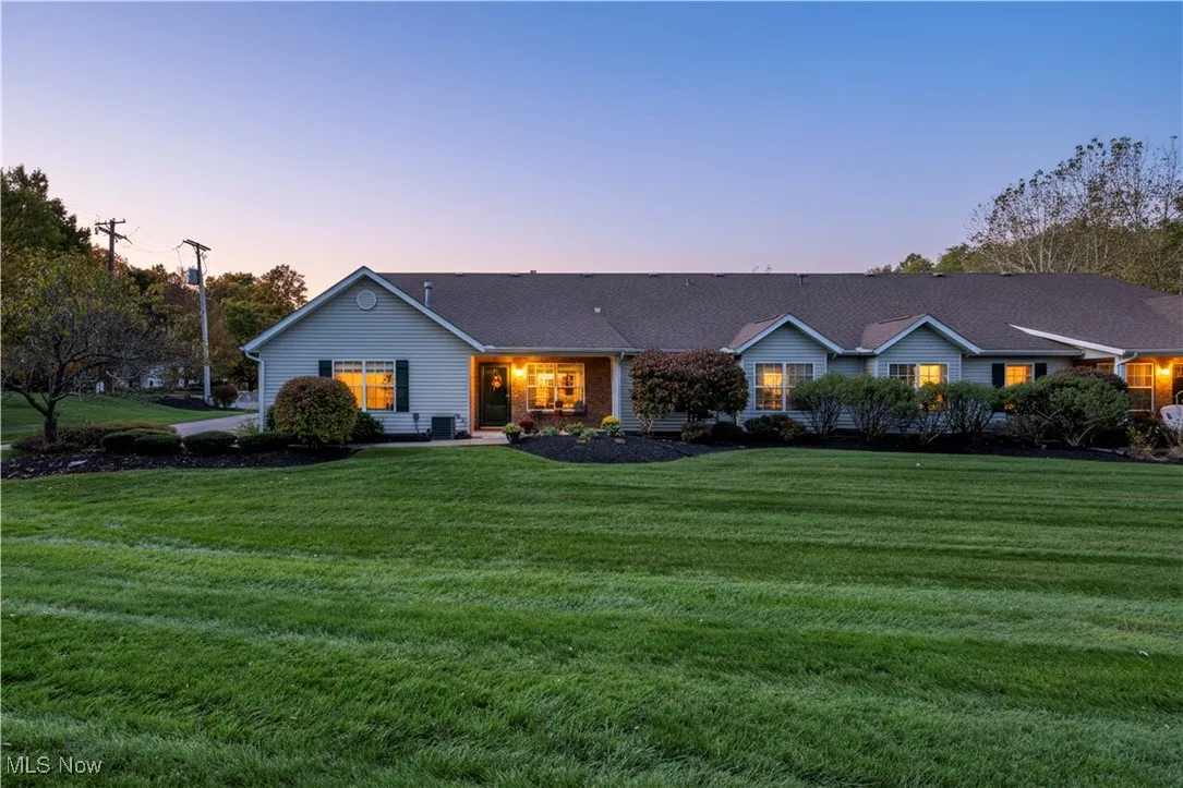 Ranch-style home featuring a front yard and roof with shingles