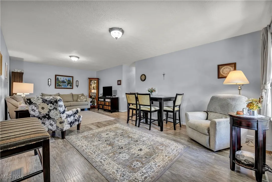 Living room featuring a textured ceiling and wood finished floors