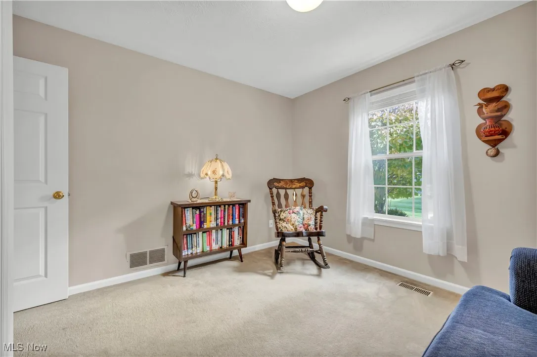 Living area with carpet and baseboards