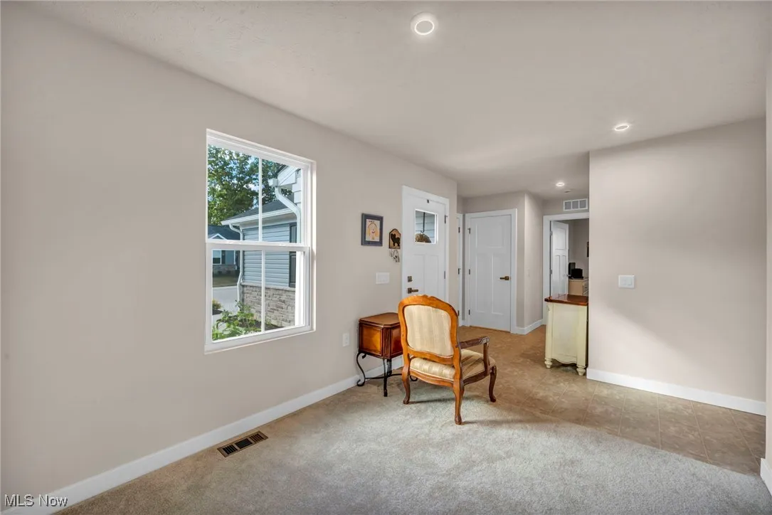 Living area featuring recessed lighting and light colored carpet