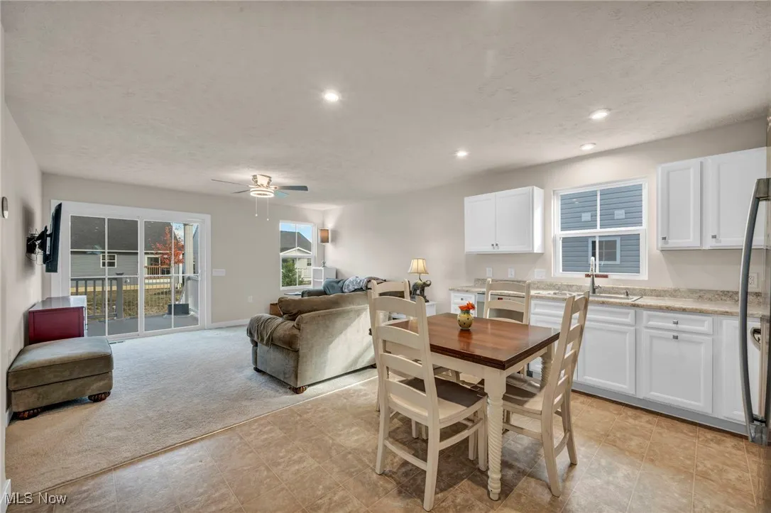Dining space with recessed lighting, a textured ceiling, ceiling fan, and light colored carpet