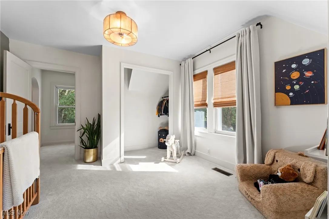 Living area with carpet and arched walkways