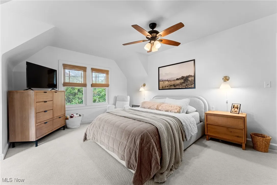 Bedroom featuring carpet floors, a ceiling fan, and lofted ceiling