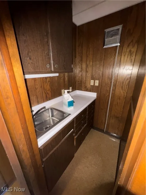 Bathroom featuring vanity and wooden walls