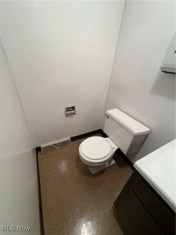 Bathroom with tile patterned floors and vanity