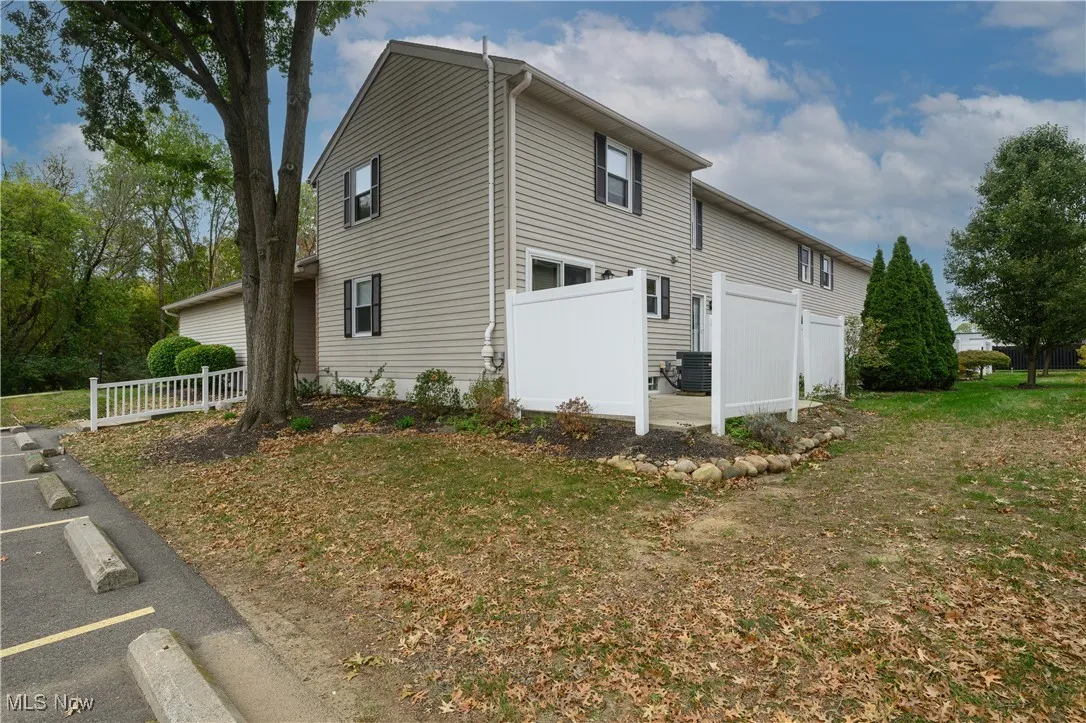 View of side of home with a cooling unit