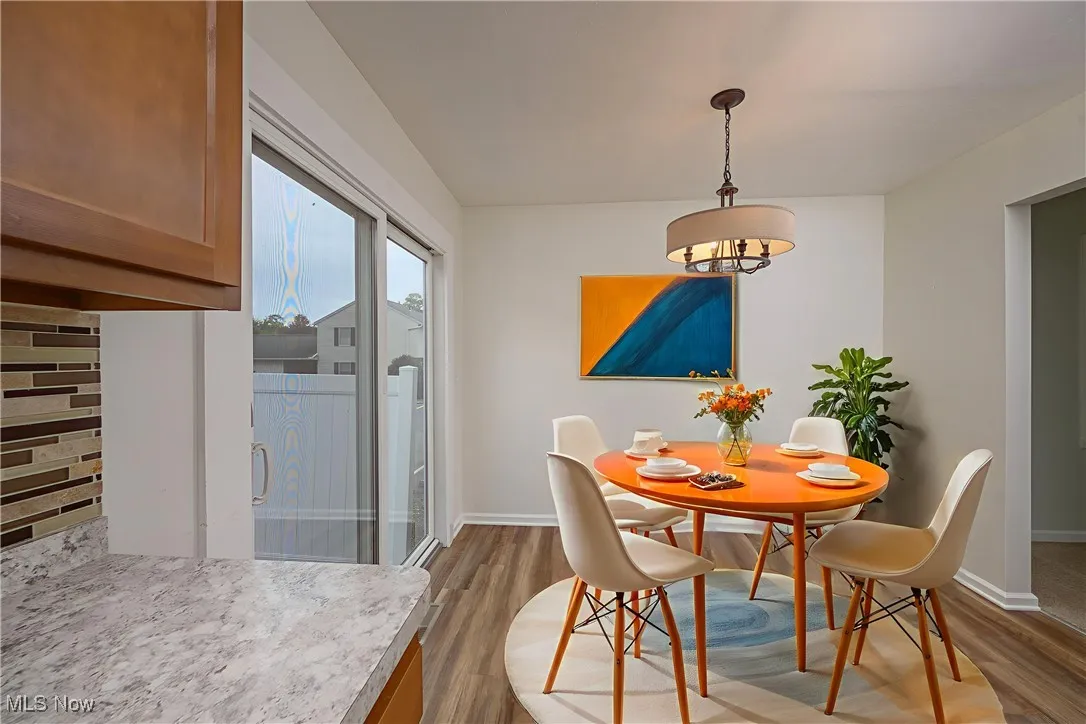 Dining area with light wood-style flooring and baseboards