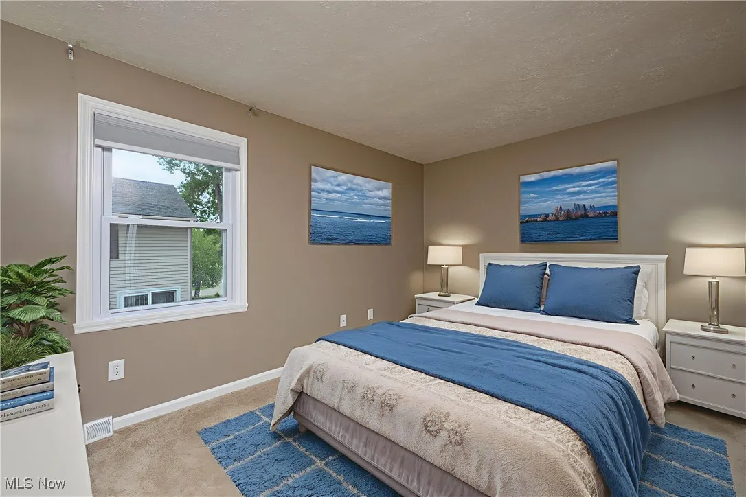 Carpeted bedroom featuring a textured ceiling