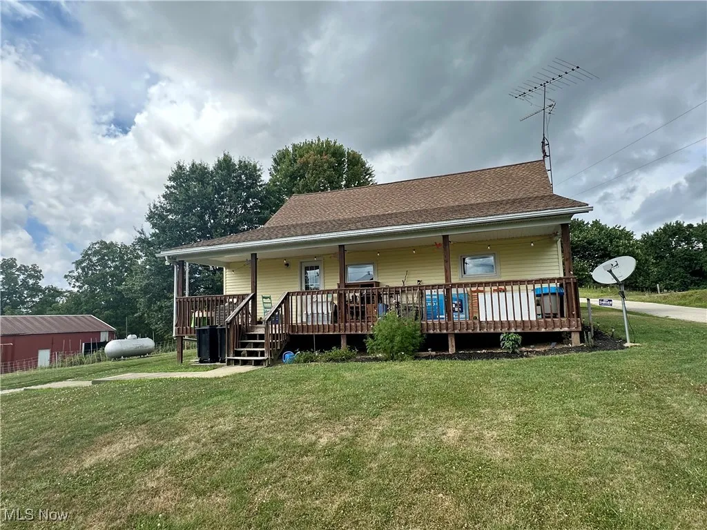Rear/front of property with a Porch and a lawn