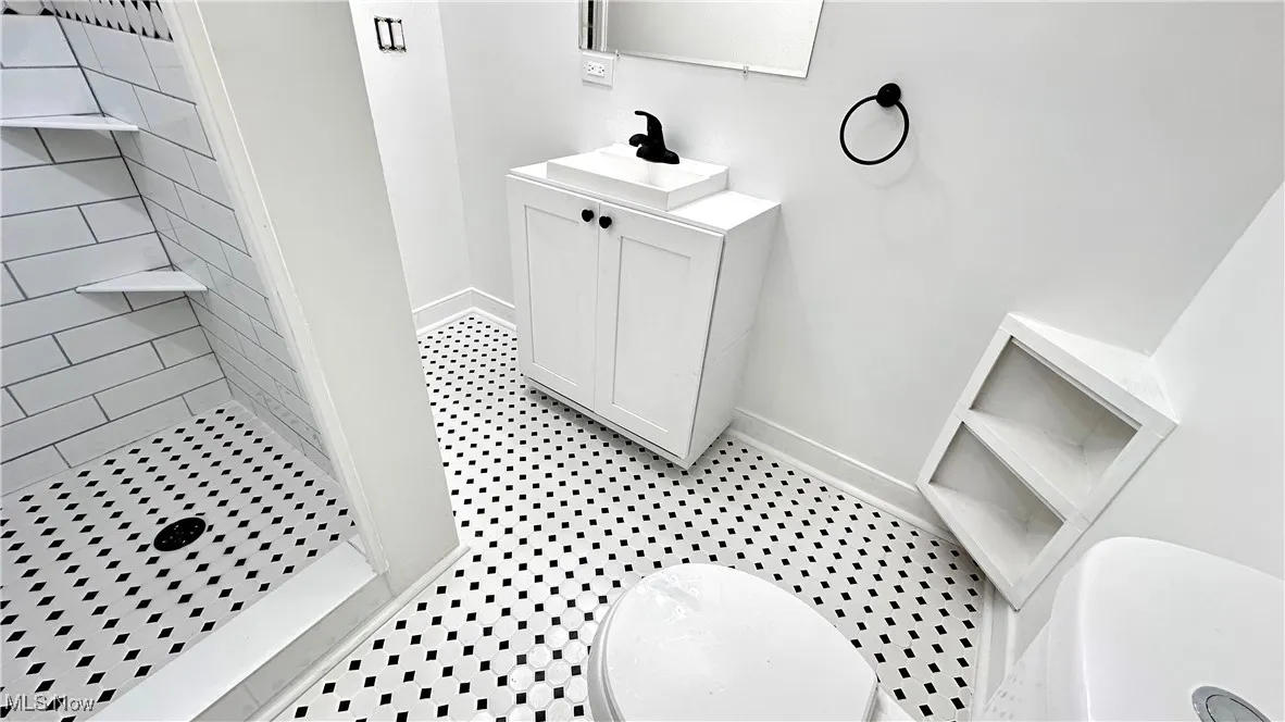 Bathroom with vanity and a shower stall
