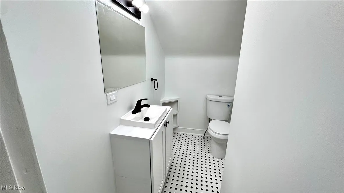 Half bath with vanity and toilet