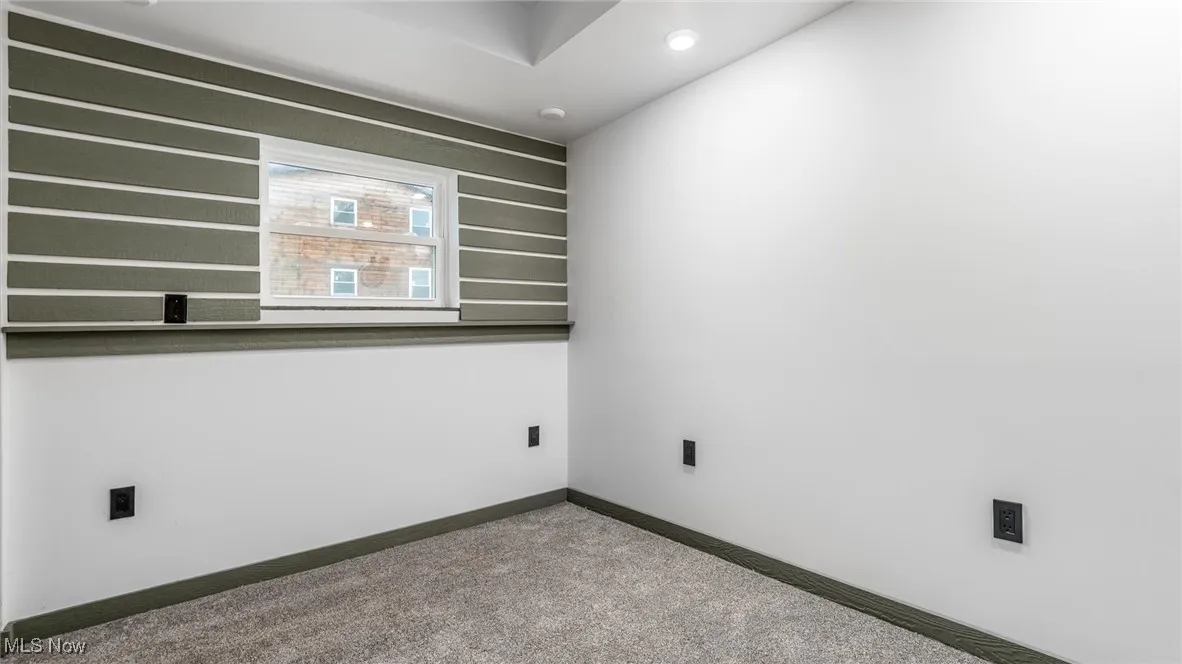 Carpeted empty room with baseboards