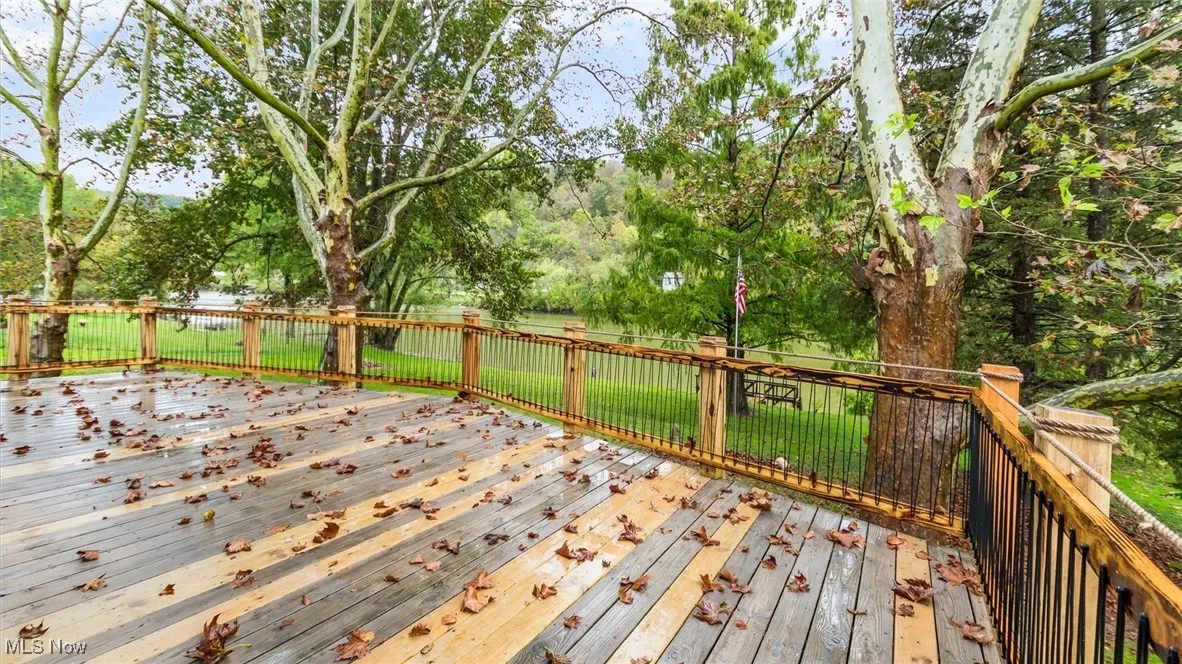 Wooden terrace featuring a yard