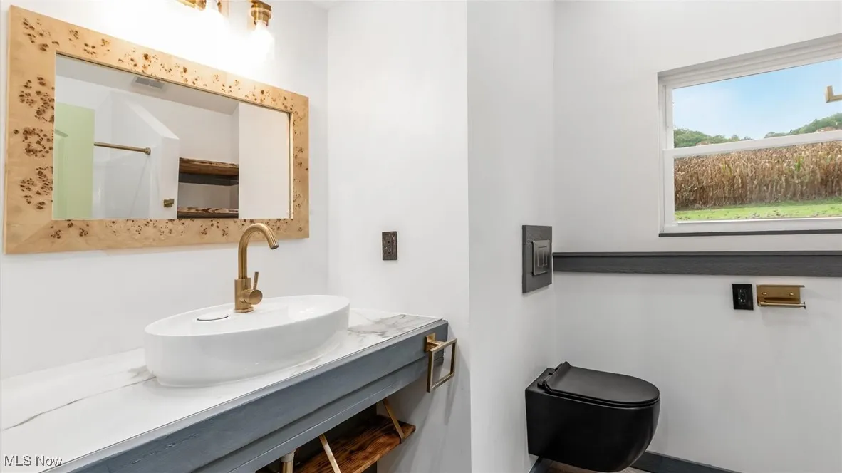 Full bathroom featuring an enclosed shower and vanity
