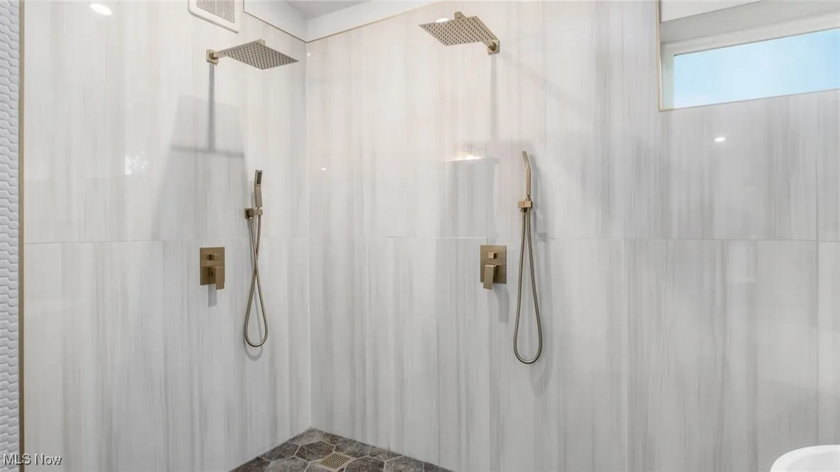 Full bathroom featuring tiled shower