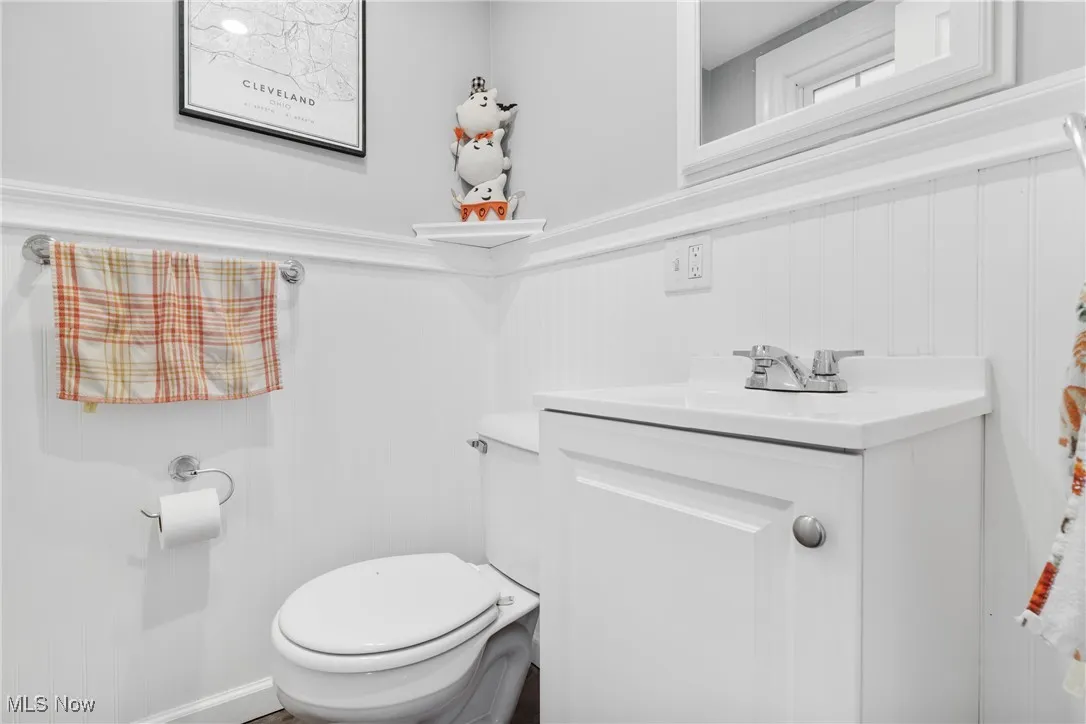 Bathroom with vanity and a wainscoted wall